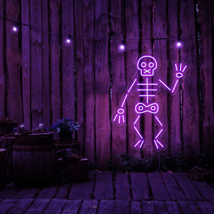 purple skeleton neon sign hanging on timber fence