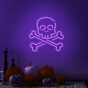 purple skull bones neon sign with pumpkins on floor