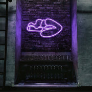 purple smoking lips neon sign hanging on bar wall