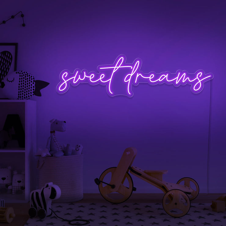 purple sweet dreams neon sign hanging on kids bedroom wall