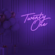 purple  twenty one neon sign hanging on wall with balloons