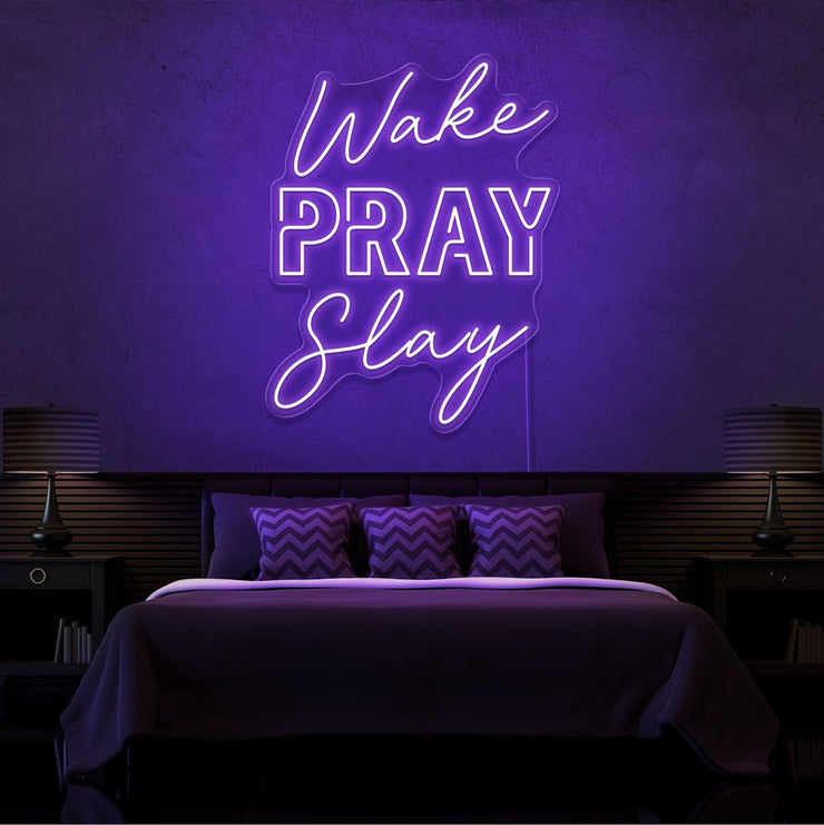 purple wake pray slay neon sign hanging on bedroom wall
