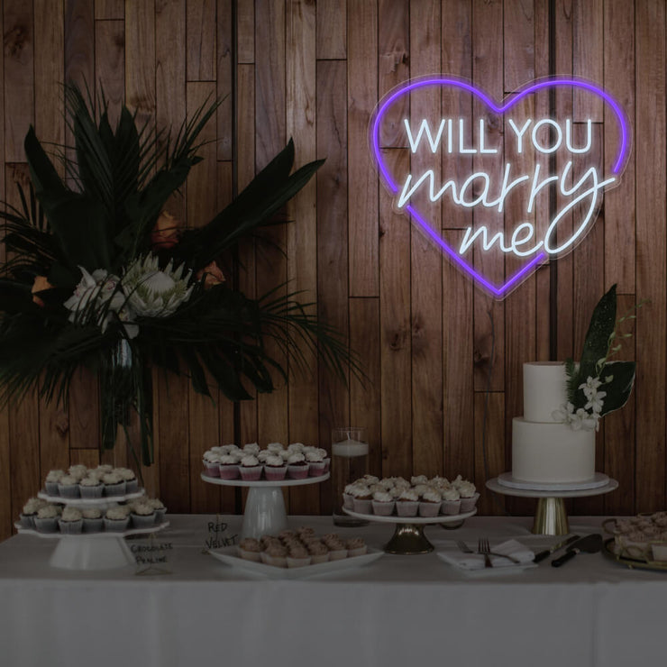 purple will you marry me heart neon sign hanging on timber wall above dessert table