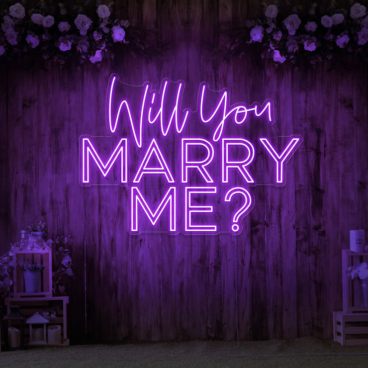 purple will you marry me neon sign hanging on timber wall