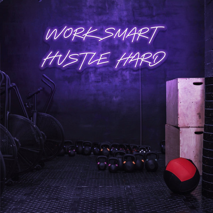 purple work smart hustle hard neon sign hanging on gym wall