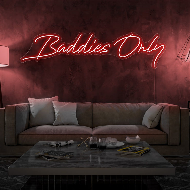 red baddies only neon sign hanging on living room wall