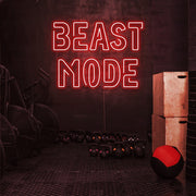 red beast mode neon sign hanging on gym wall