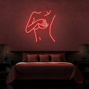 red cover up neon sign hanging on bedroom wall