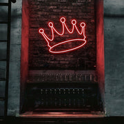 red crown neon sign hanging on bar wall