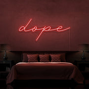 red dope cursive neon sign hanging on bedroom wall