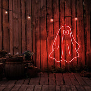 red draped ghost neon sign hanging on timber wall