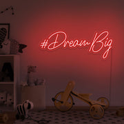 red dream big neon sign hanging on kids bedroom wall