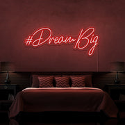 red dream big neon sign hanging on bedroom wall