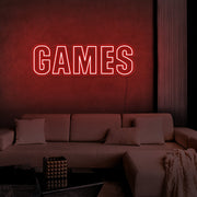 red games neon sign hanging on games room wall