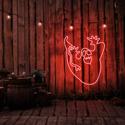 red ghost neon sign hanging on timber wall