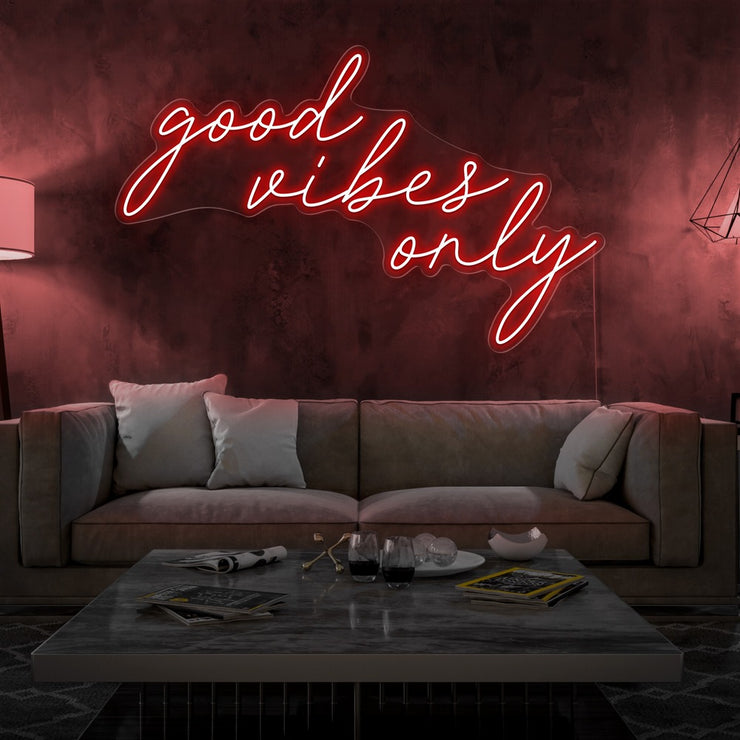 red good vibes only neon sign hanging on living room wall