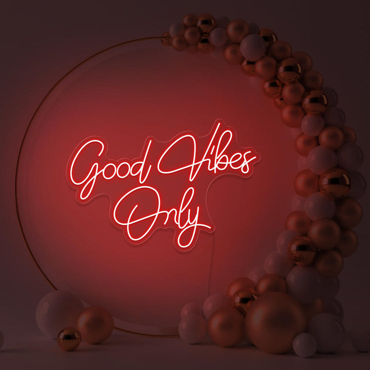 red good vibes only neon sign hanging inside balloon hoop backdrop