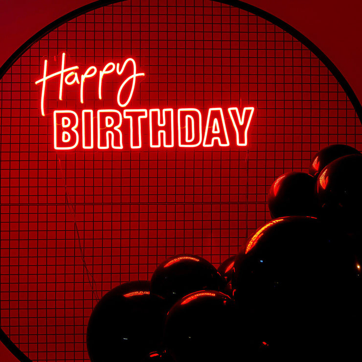 red happy birthday neon sign on black mesh backdrop frame