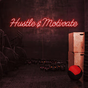 red hustle and motivate neon sign hanging on gym wall