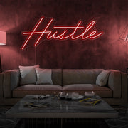 red hustle neon sign hanging on living room wall
