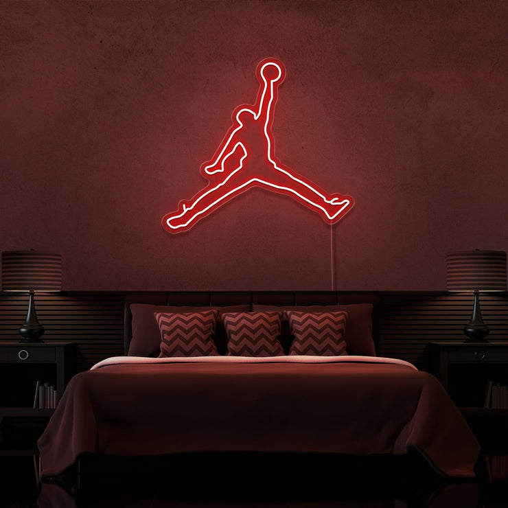 red jordan jumpman neon sign hanging on bedroom wall