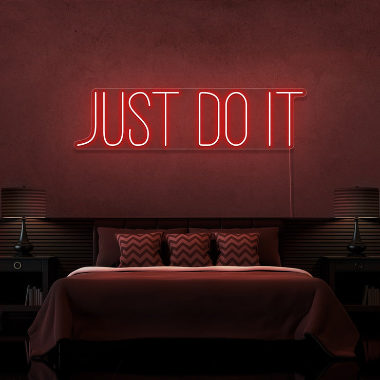 red just do it neon sign hanging on bedroom wall
