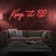 red keep it 100 neon sign hanging on living room wall