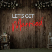 red lets get married neon sign hanging on timber wall