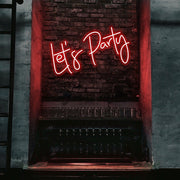 red lets party neon sign hanging on bar wall