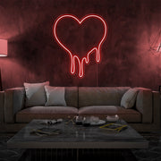 red melting heart neon sign hanging on living room wall