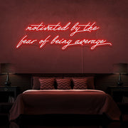 red motivated by the fear of being average neon sign hanging on bedroom wall