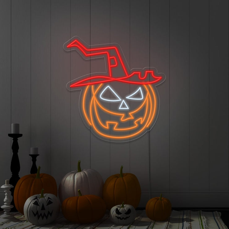 red pumpkin hat neon sign hanging on wall next to pumpkins
