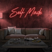 red self made neon sign hanging on living room wall