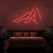 red sexy legs neon sign hanging on bedroom wall
