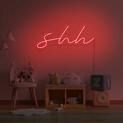 red shh neon sign hanging on kids bedroom wall