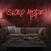 red sicko mode neon sign hanging on living room wall