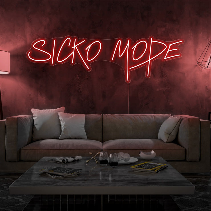 red sicko mode neon sign hanging on living room wall