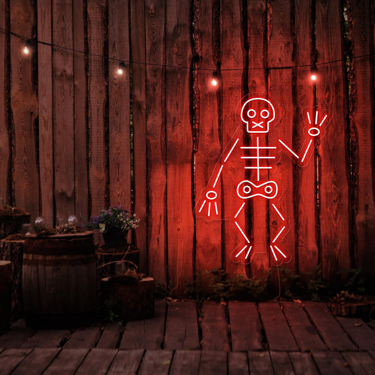 red skeleton neon sign hanging on timber fence