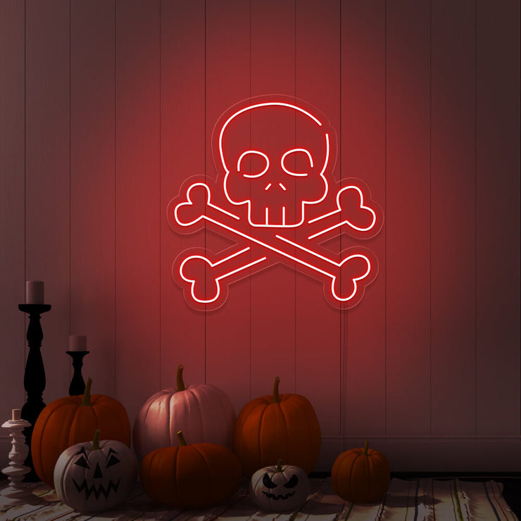 red skull bones neon sign with pumpkins on floor