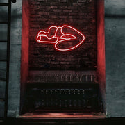 red smoking lips neon sign hanging on bar wall