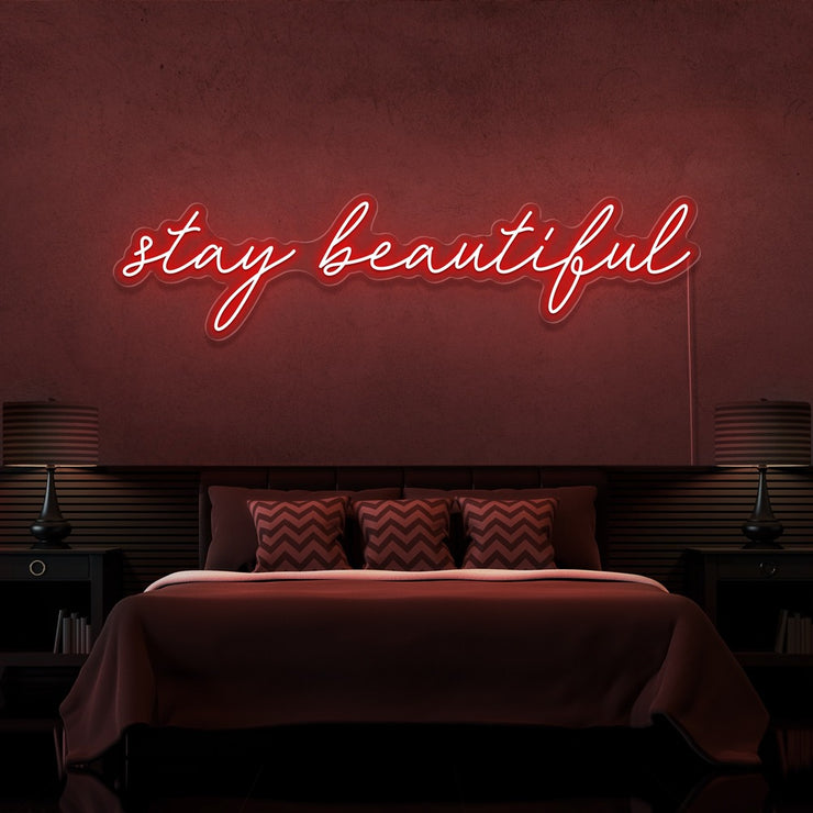red stay beautiful neon sign hanging on bedroom wall