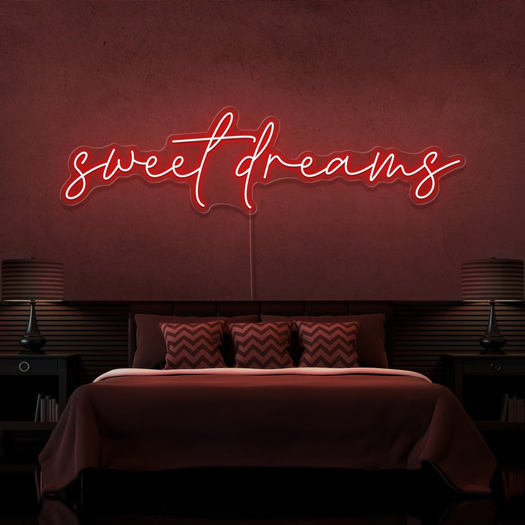 red sweet dreams neon sign hanging on bedroom wall