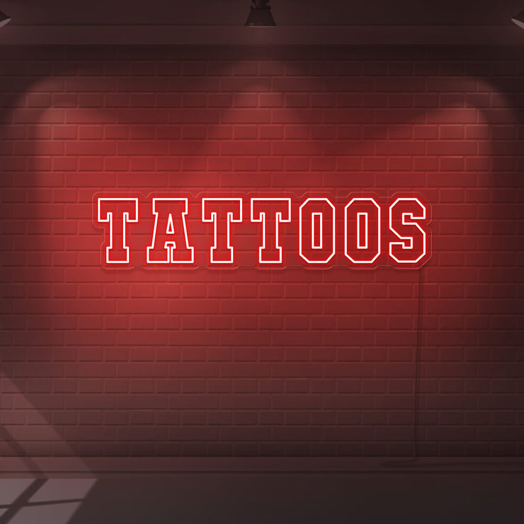 red tattoos neon sign hanging on wall