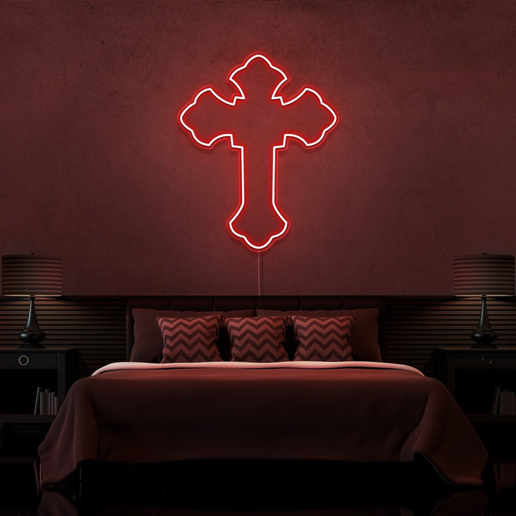 red tupac cross neon sign hanging on bedroom wall