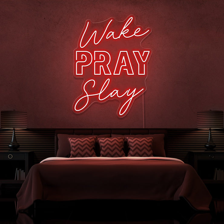 red wake pray slay neon sign hanging on bedroom wall