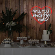 red will you marry me heart neon sign hanging on timber wall above dessert table