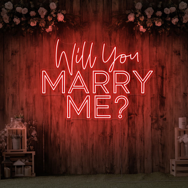 red will you marry me neon sign hanging on timber wall