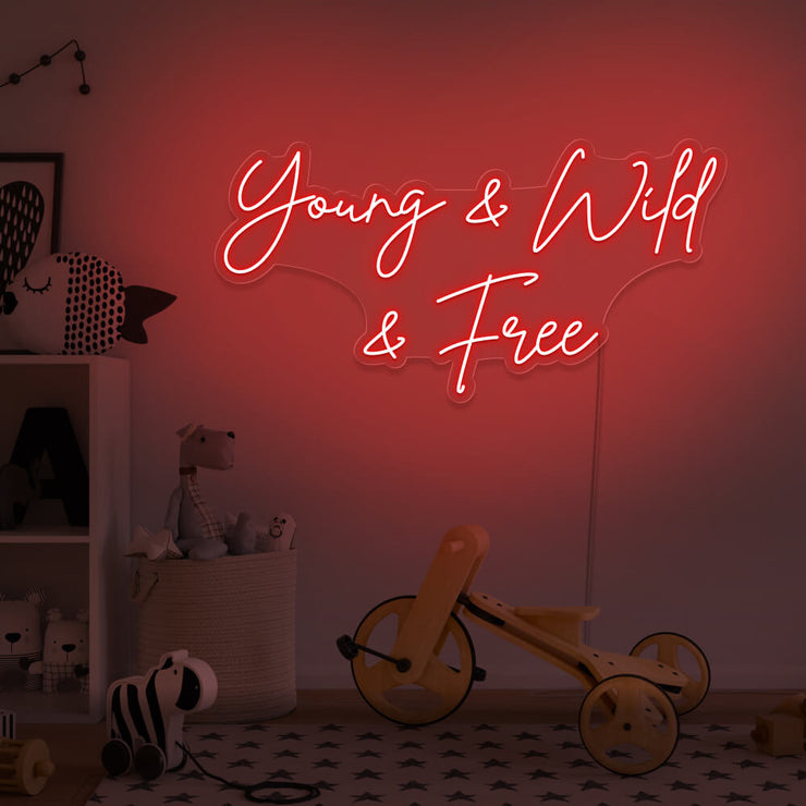 red young wild and free neon sign hanging on kids bedroom wall