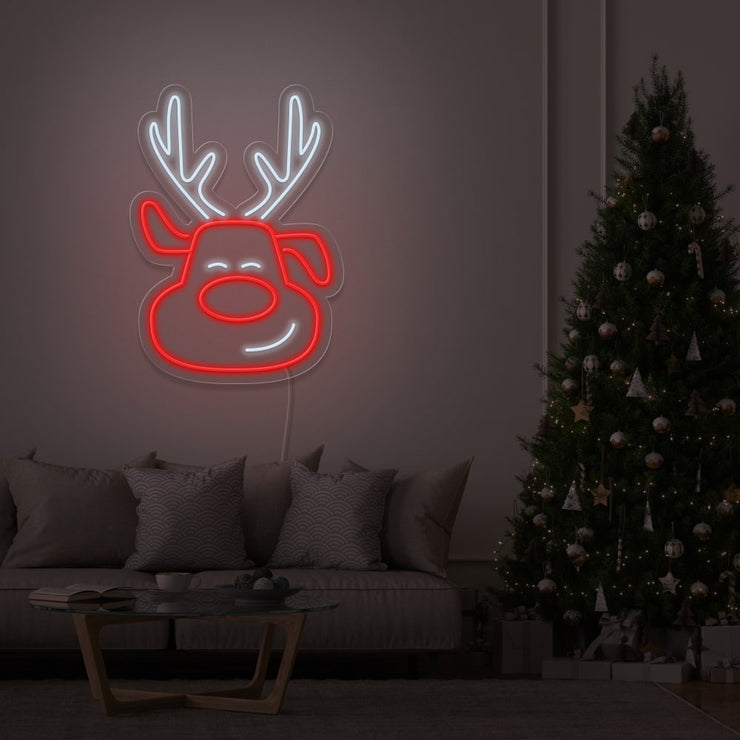 rudolph neon sign hanging on living room wall next to christmas tree