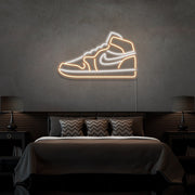 warm white air jordan 1 sneaker neon sign hanging on bedroom wall